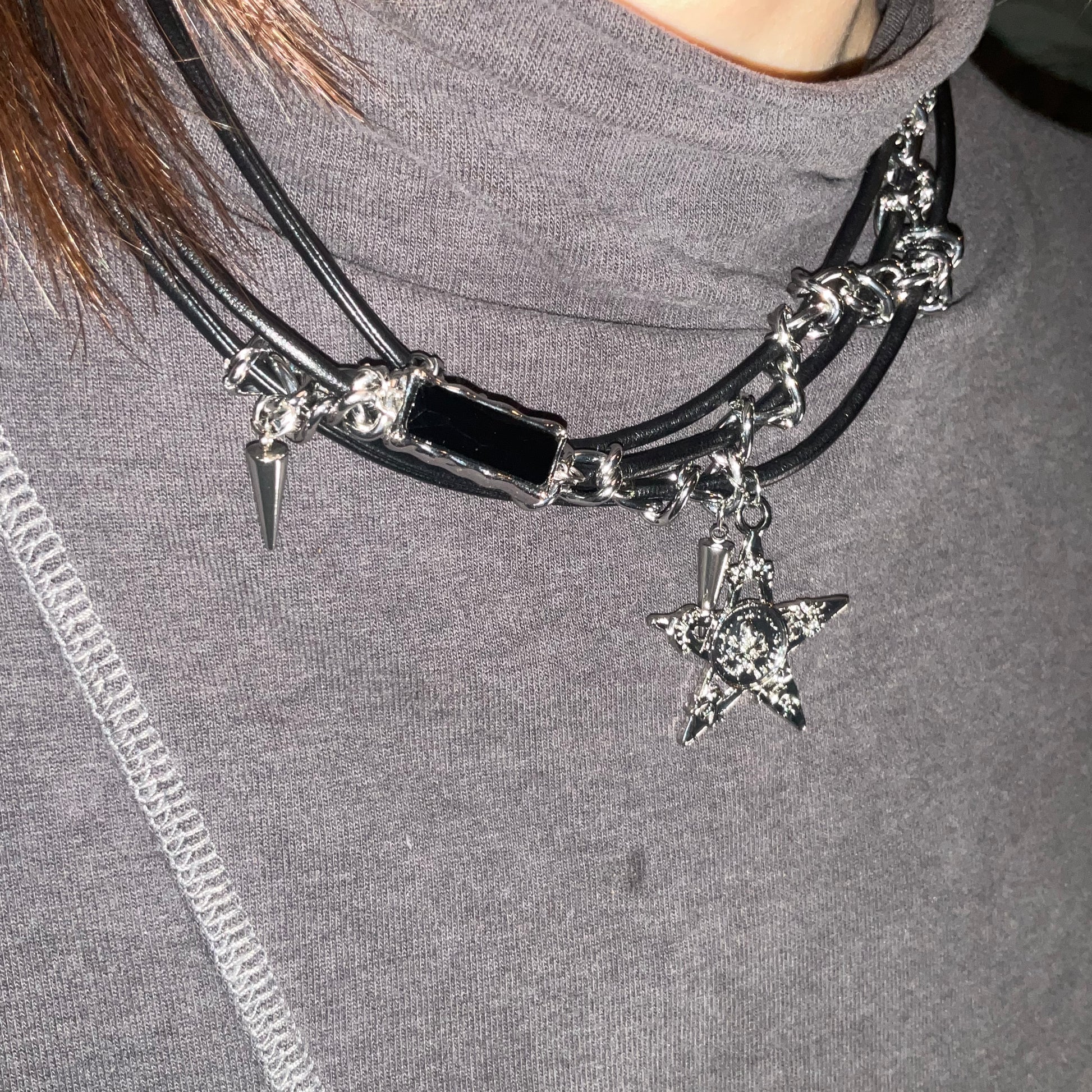 Necklace with star charm on a gray background
